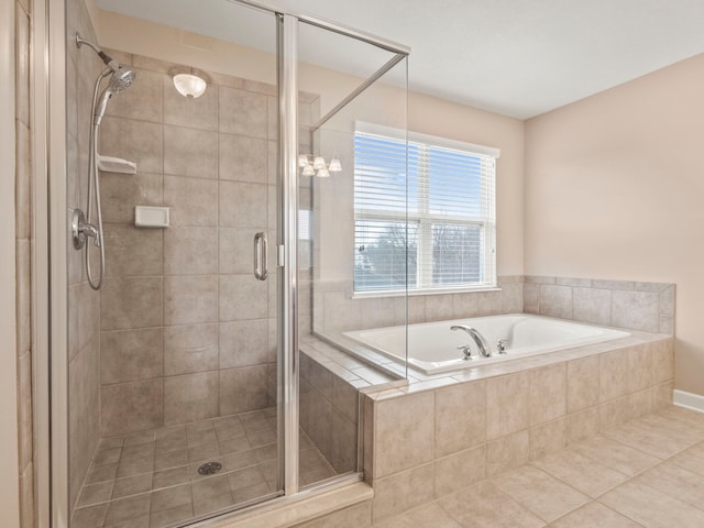 bathroom featuring a bath, tile patterned flooring, and a stall shower