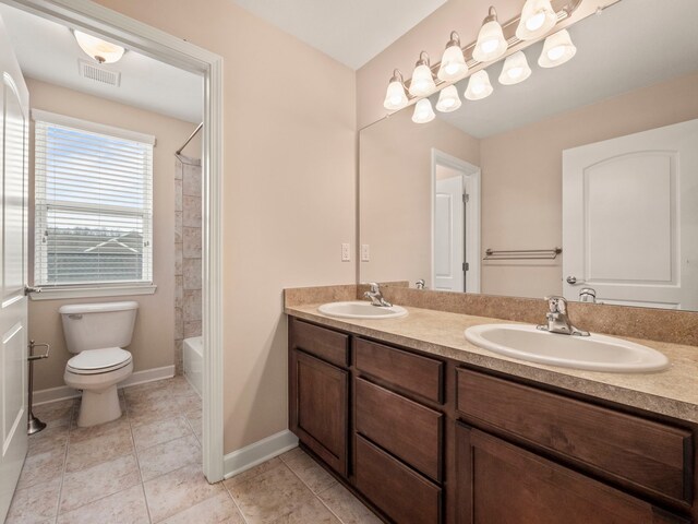 bathroom with tile patterned floors, toilet, visible vents, and a sink