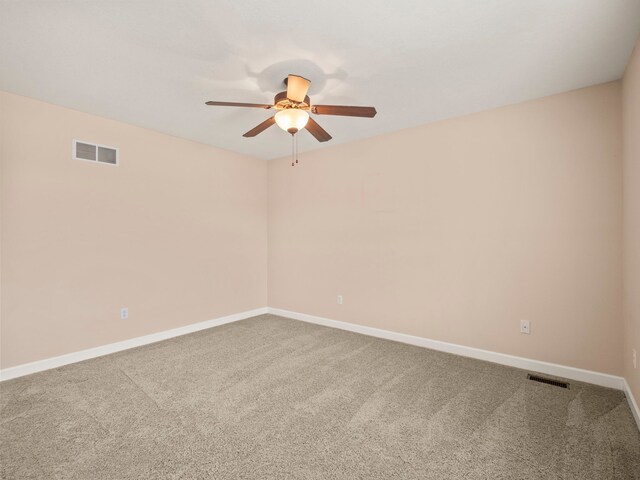 unfurnished room featuring visible vents, carpet floors, baseboards, and ceiling fan