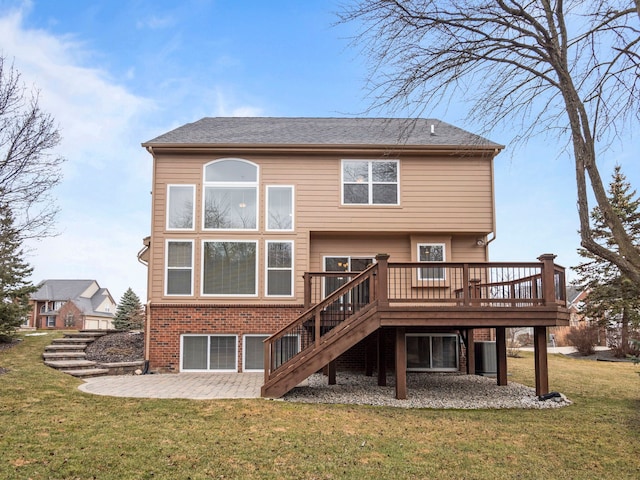 back of property featuring a wooden deck, a patio, a lawn, and stairs