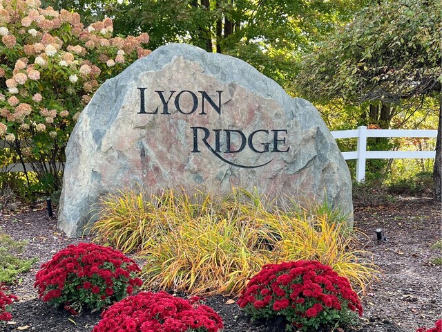 community sign featuring fence