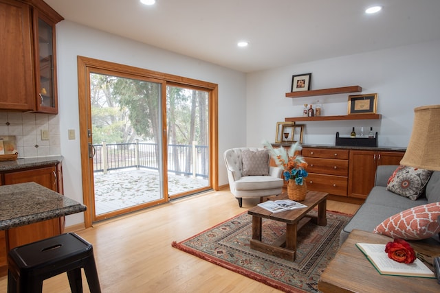 living room with light wood-type flooring and recessed lighting