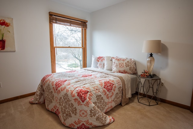 bedroom featuring carpet and baseboards