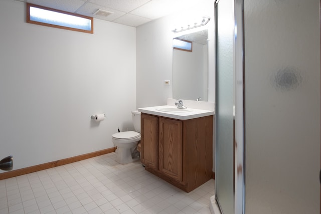 bathroom with visible vents, toilet, vanity, a paneled ceiling, and a shower stall