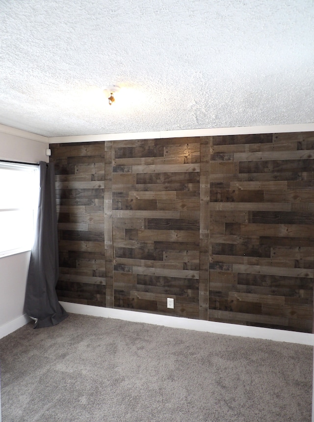 interior space with wooden walls and a textured ceiling