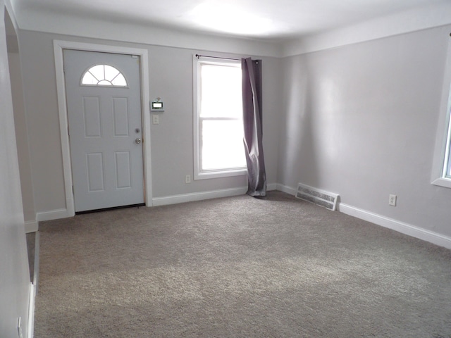 carpeted entrance foyer with visible vents and baseboards