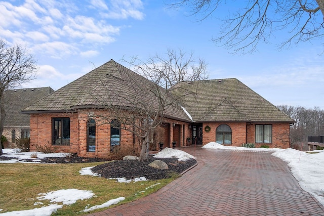 view of front of property with brick siding and decorative driveway