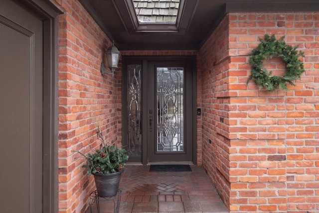 property entrance featuring brick siding