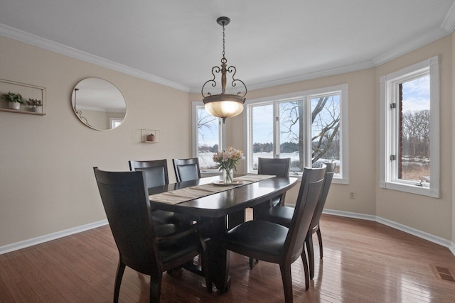 dining area featuring plenty of natural light, baseboards, visible vents, and wood-type flooring