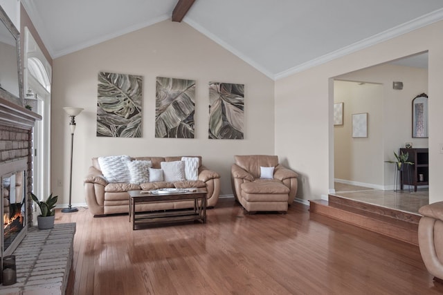 living area featuring a fireplace, lofted ceiling with beams, baseboards, and wood finished floors