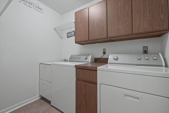 laundry room featuring cabinet space, independent washer and dryer, and baseboards