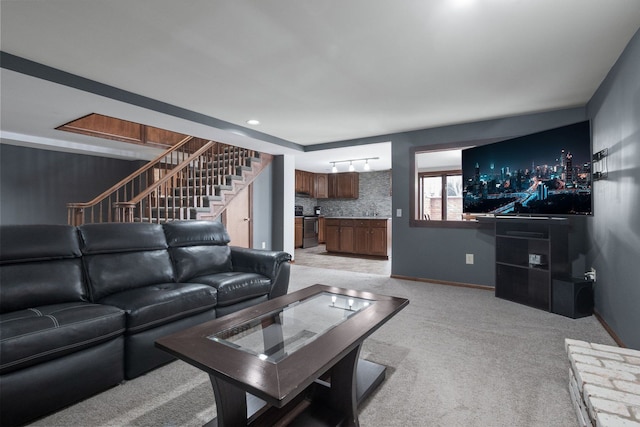 living area with stairs, light colored carpet, and baseboards