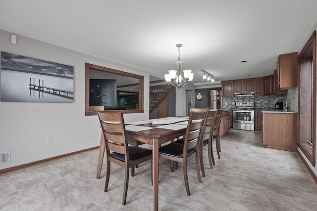 dining room with visible vents, baseboards, a notable chandelier, and stairway