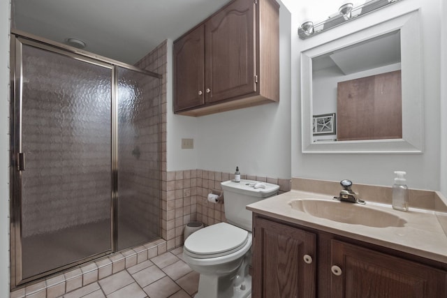 full bath with tile walls, toilet, a stall shower, tile patterned floors, and vanity