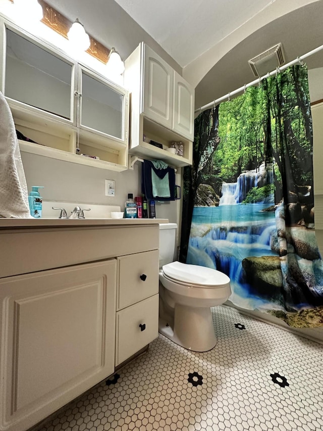 bathroom featuring toilet, visible vents, and vanity