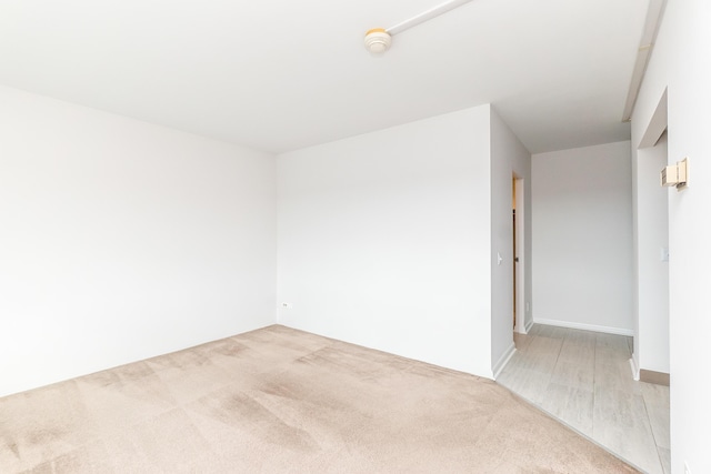 unfurnished room with light carpet