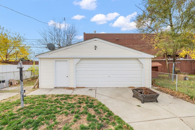 detached garage featuring fence