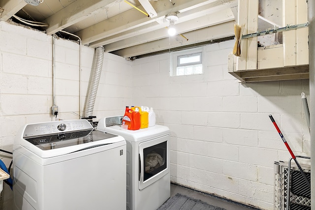 clothes washing area featuring laundry area and washing machine and clothes dryer