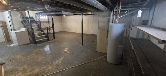 below grade area featuring water heater and washer / clothes dryer