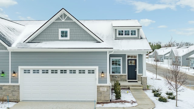 view of front of house featuring stone siding and driveway