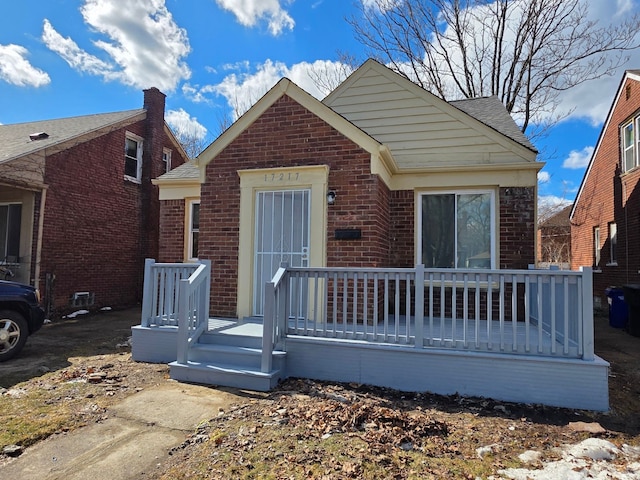 bungalow-style home with brick siding