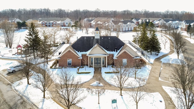 snowy aerial view with a residential view