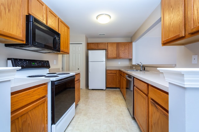 kitchen with dishwasher, freestanding refrigerator, light countertops, black microwave, and range with electric stovetop