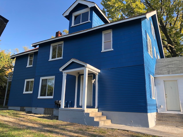 view of front of house featuring a chimney