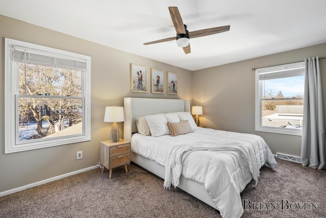 bedroom with ceiling fan, baseboards, and dark colored carpet