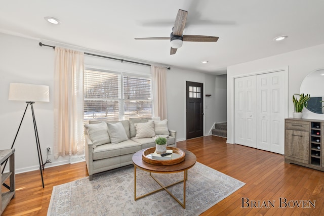 living area with stairs, hardwood / wood-style floors, and recessed lighting