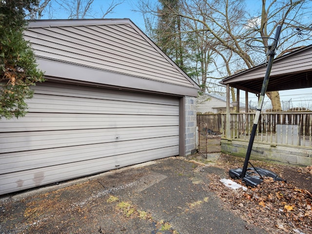 garage with driveway and fence