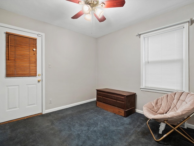 sitting room with ceiling fan, carpet floors, and baseboards