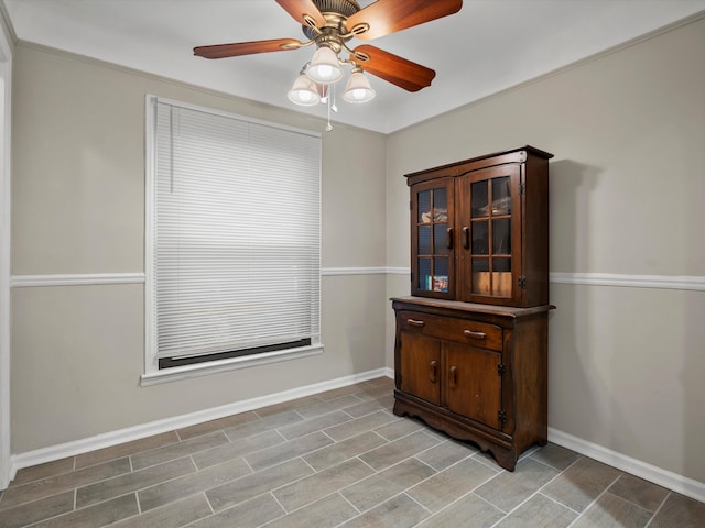 dining space with baseboards and a ceiling fan