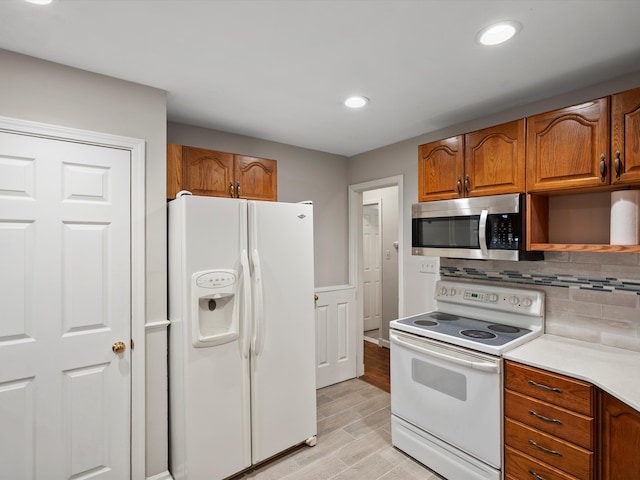 kitchen with open shelves, decorative backsplash, brown cabinetry, wood tiled floor, and white appliances