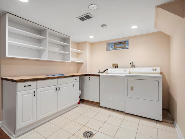 clothes washing area featuring recessed lighting, cabinet space, visible vents, light tile patterned flooring, and independent washer and dryer