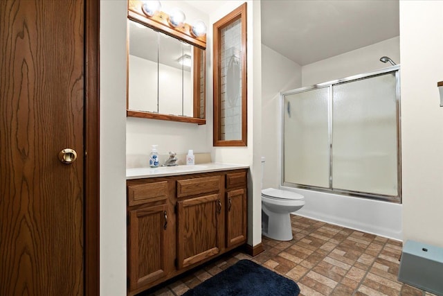 full bath with toilet, vanity, and enclosed tub / shower combo