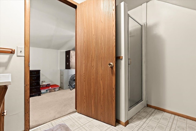 full bathroom with a shower stall, baseboards, and tile patterned floors