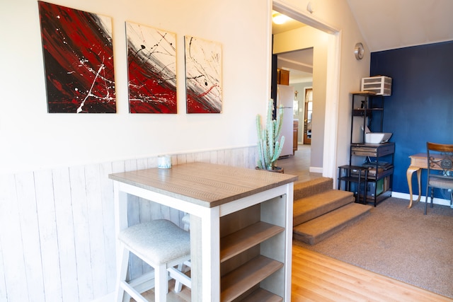 carpeted dining room with wood finished floors