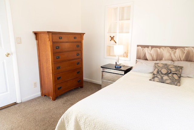 carpeted bedroom featuring baseboards