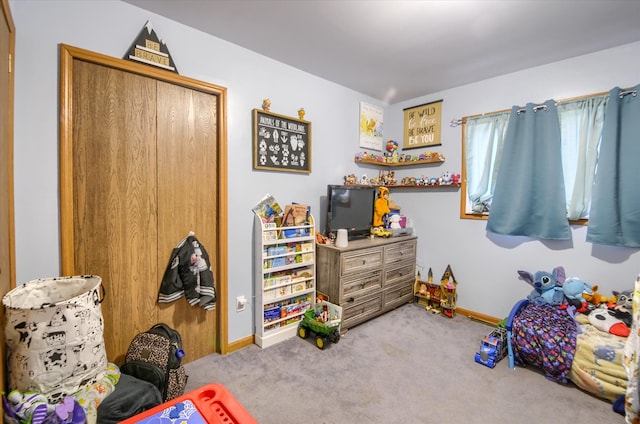 carpeted bedroom featuring baseboards