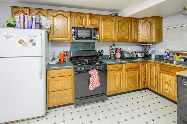 kitchen with brown cabinets, black appliances, light floors, and a sink