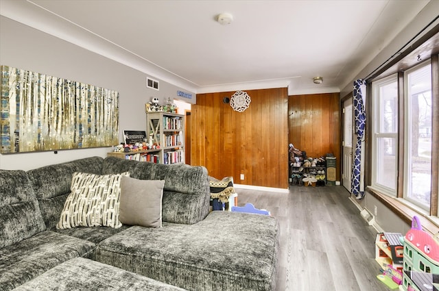 living area featuring wood finished floors and visible vents