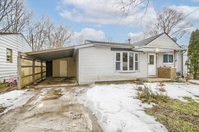 view of front of property with driveway and a carport