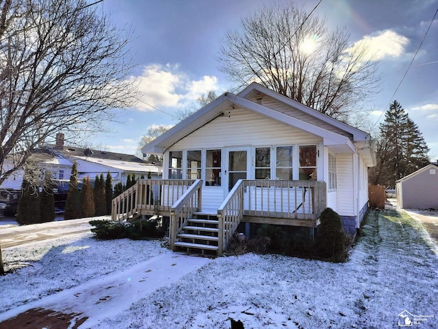 bungalow-style house with stairway and a wooden deck