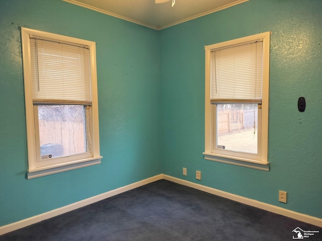 empty room featuring ceiling fan, ornamental molding, carpet, and baseboards