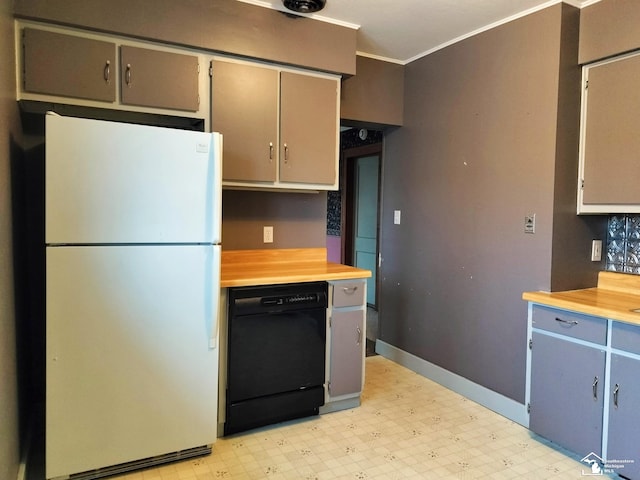 kitchen with freestanding refrigerator, black dishwasher, crown molding, and light floors