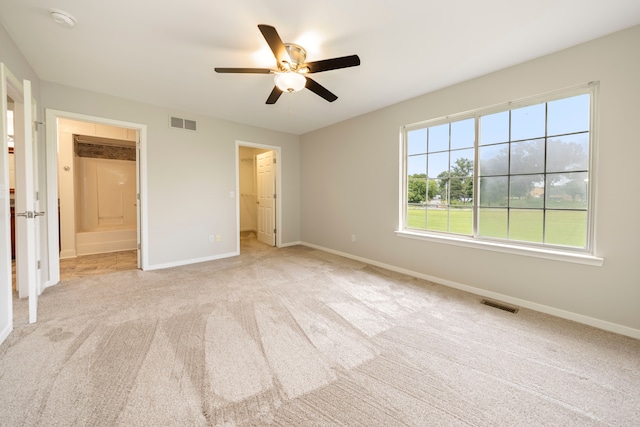 unfurnished bedroom featuring baseboards, visible vents, and light colored carpet