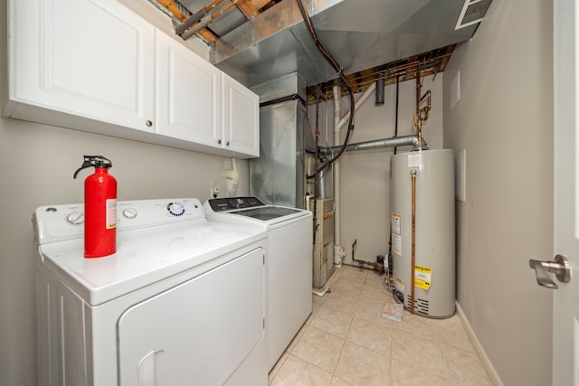 laundry room with cabinet space, light tile patterned floors, visible vents, independent washer and dryer, and gas water heater