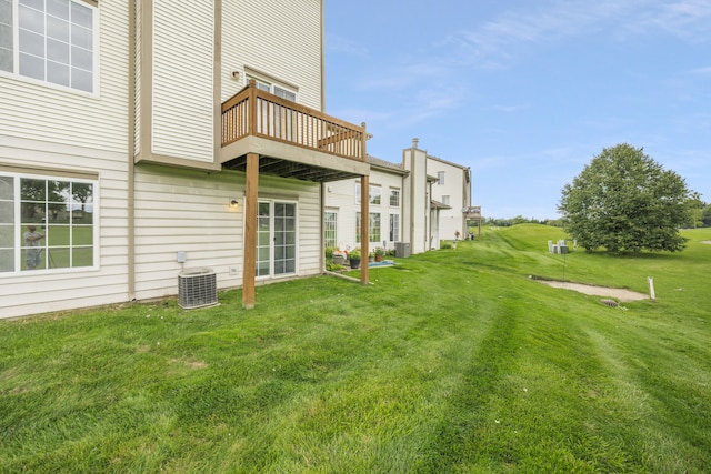 view of yard with a balcony and central AC unit