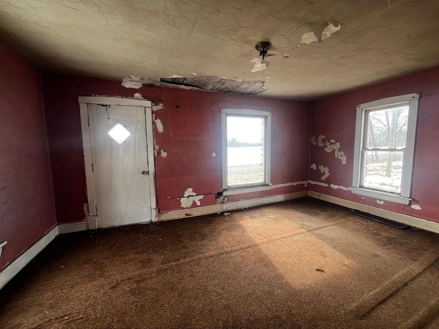 carpeted foyer entrance featuring baseboards